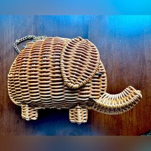 Alessia Blanche whimsical wicker elephant bag with crossbody chain strap.